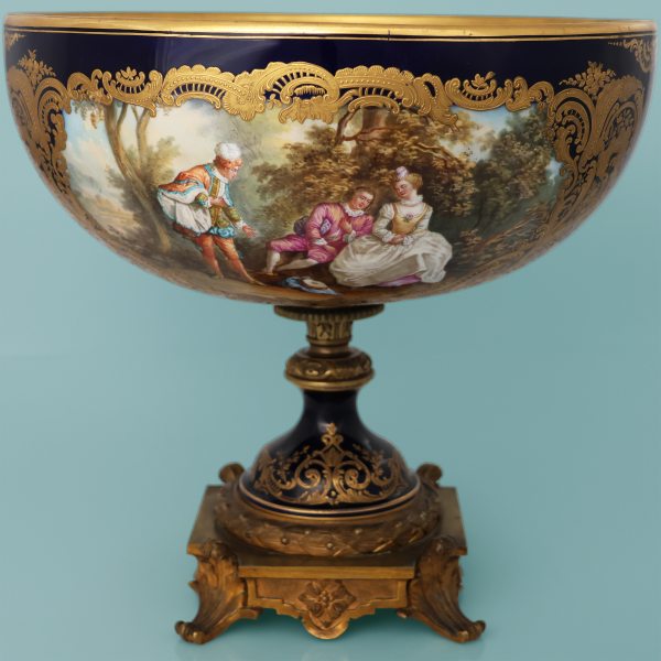 A French cup depicting gallant scenes, gilt-bronze mounted. Signed N. Lancret. Late 19th century