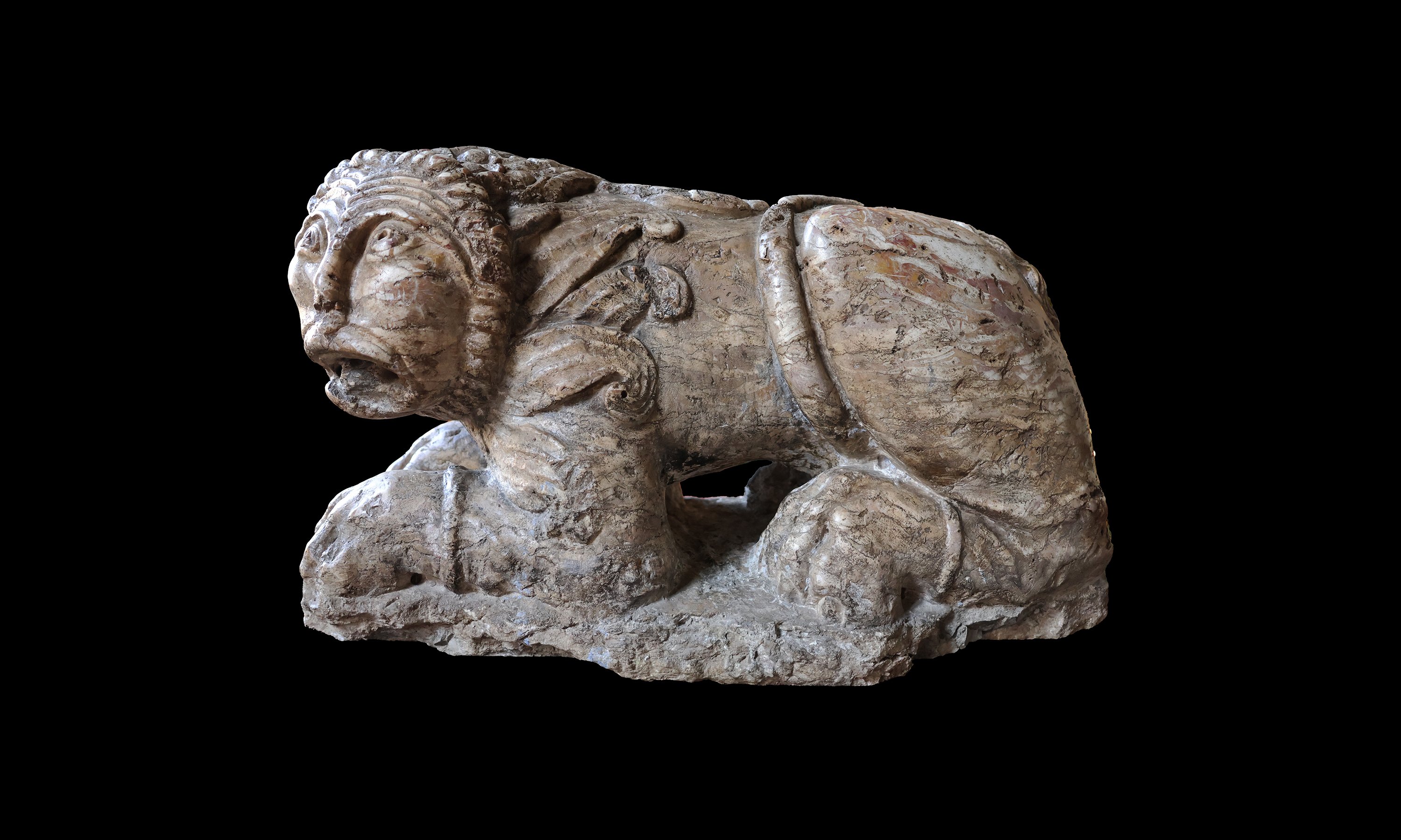 A lumachella marble recumbent lion, romanesque sculptor, 13th century